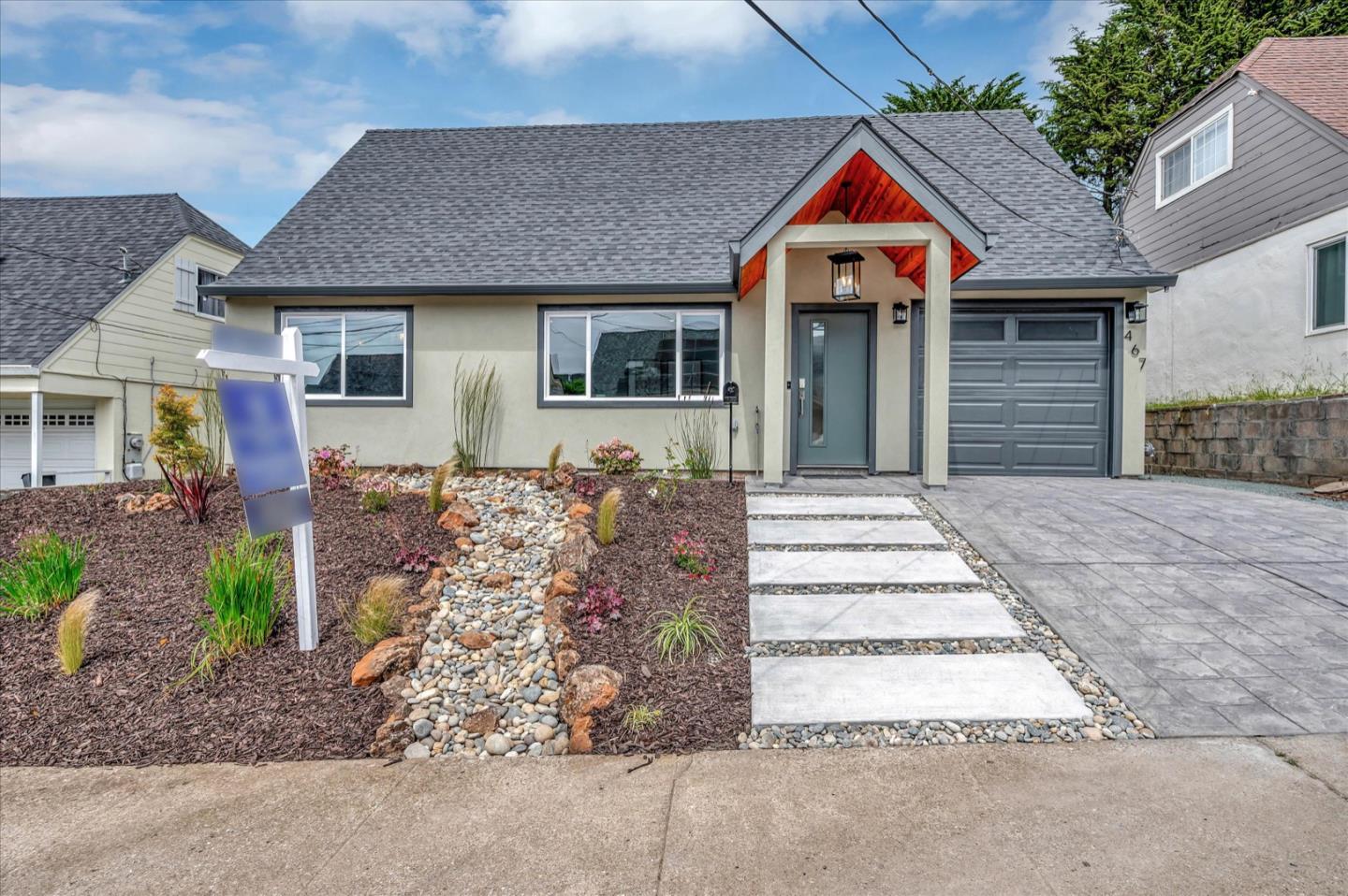 a front view of a house with garden