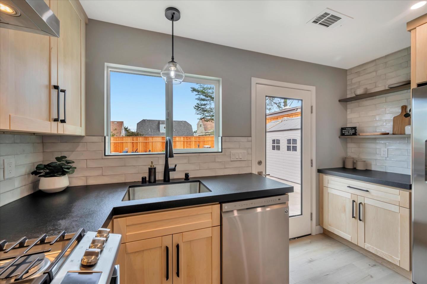467 Glasgow Drive Pacifica, CA 94044 - Photo 13 of 47 a kitchen with stainless steel appliances a sink stove and cabinets