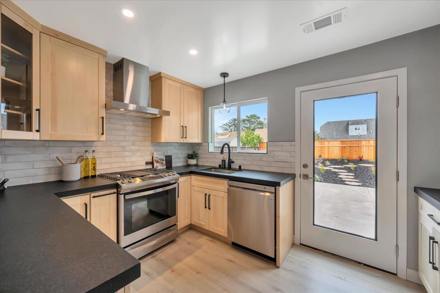 467 Glasgow Drive Pacifica, CA 94044 - Photo 15 of 47 a kitchen with stainless steel appliances granite countertop a stove a sink and a granite counter tops