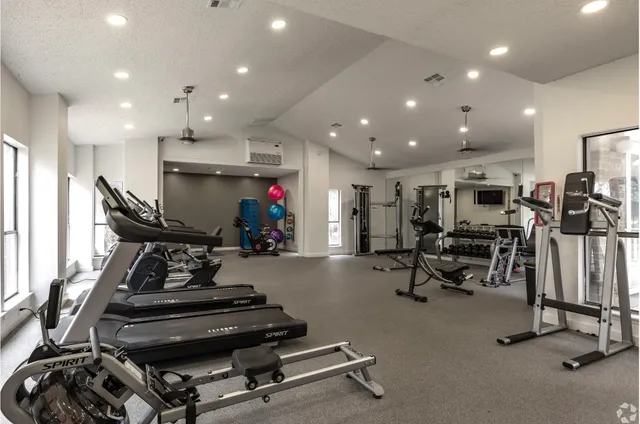 a room with gym equipment and a large window