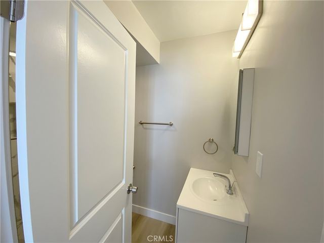 a bathroom with a sink and mirror with toilet