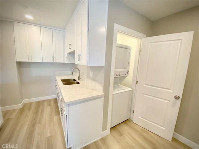 a view of storage and utility room with wooden floor