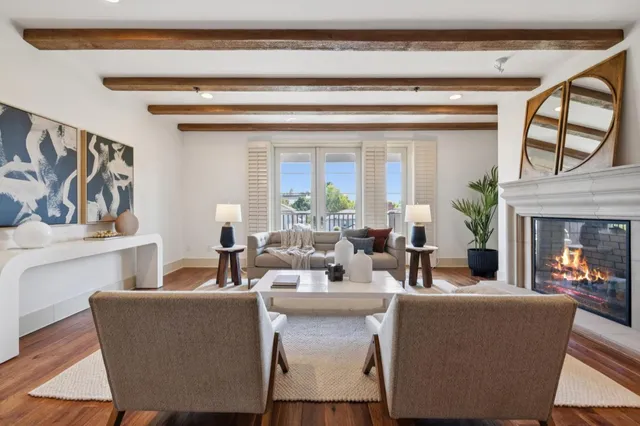 a dining room with wooden floor a glass table and chairs