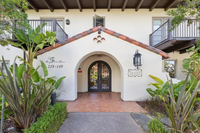 a spacious bedroom with a bed and a mirror