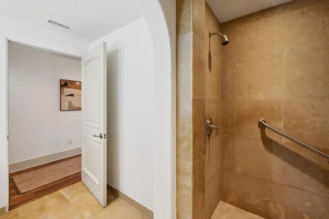 a spacious bathroom with a tub sink and mirror