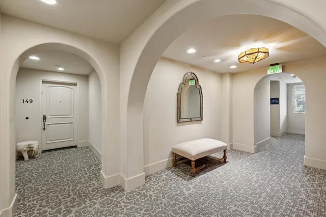 a living room with furniture a fireplace and a floor to ceiling window