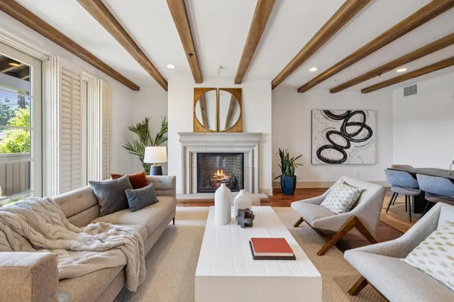 a dining room with furniture a chandelier and wooden floor