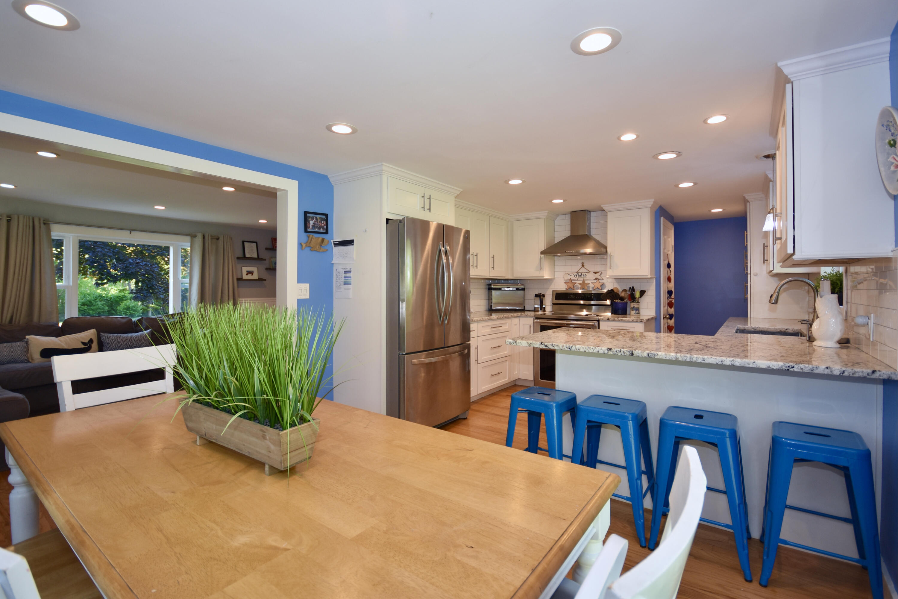15 Swift Road Sagamore Beach, MA 02562 - Photo 10 of 29 a kitchen with stainless steel appliances a dining table chairs and refrigerator