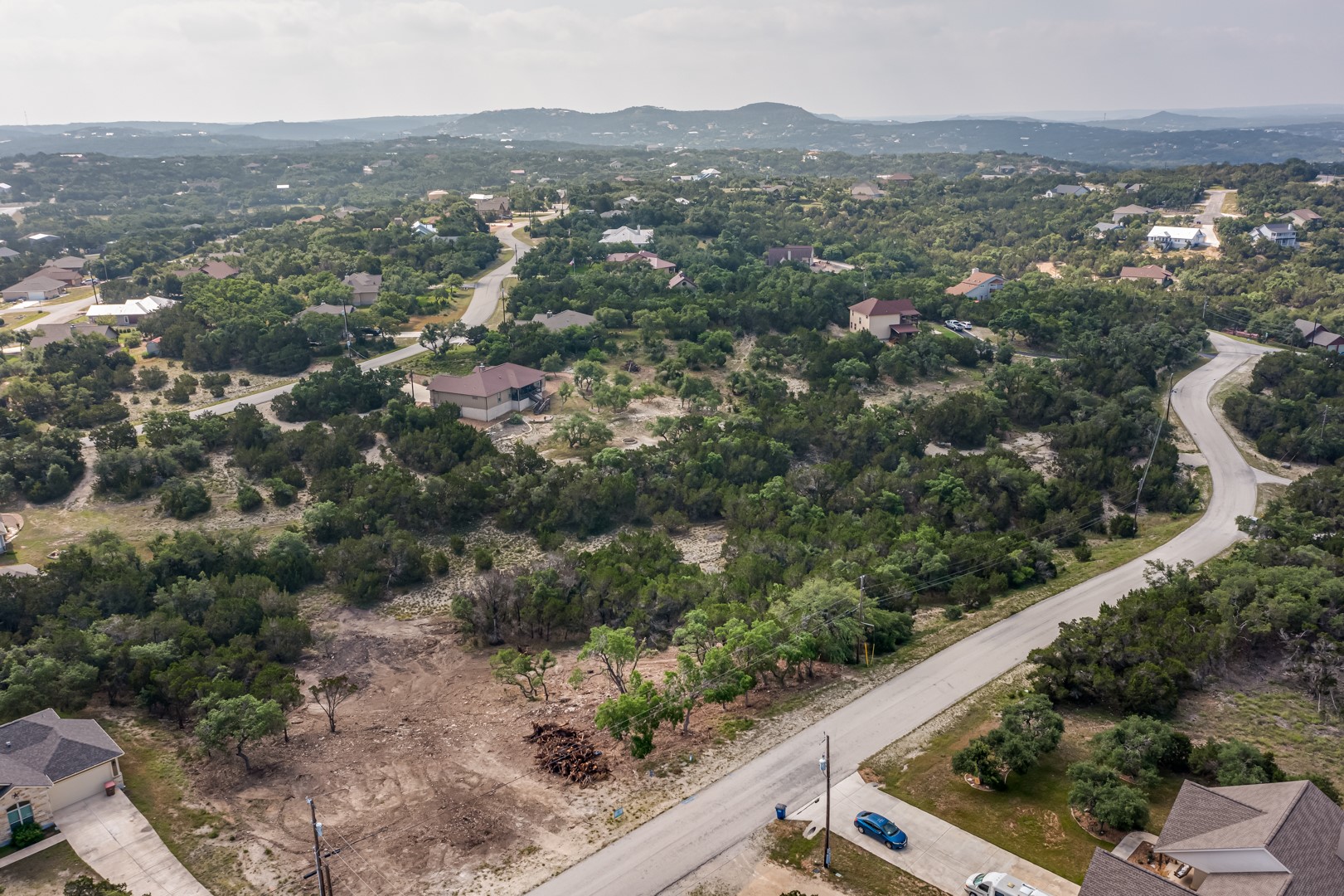 1252 Parton Road Canyon Lake, TX 78133 - Photo 4 of 11 an aerial view of residential house with parking space and mountain view in back