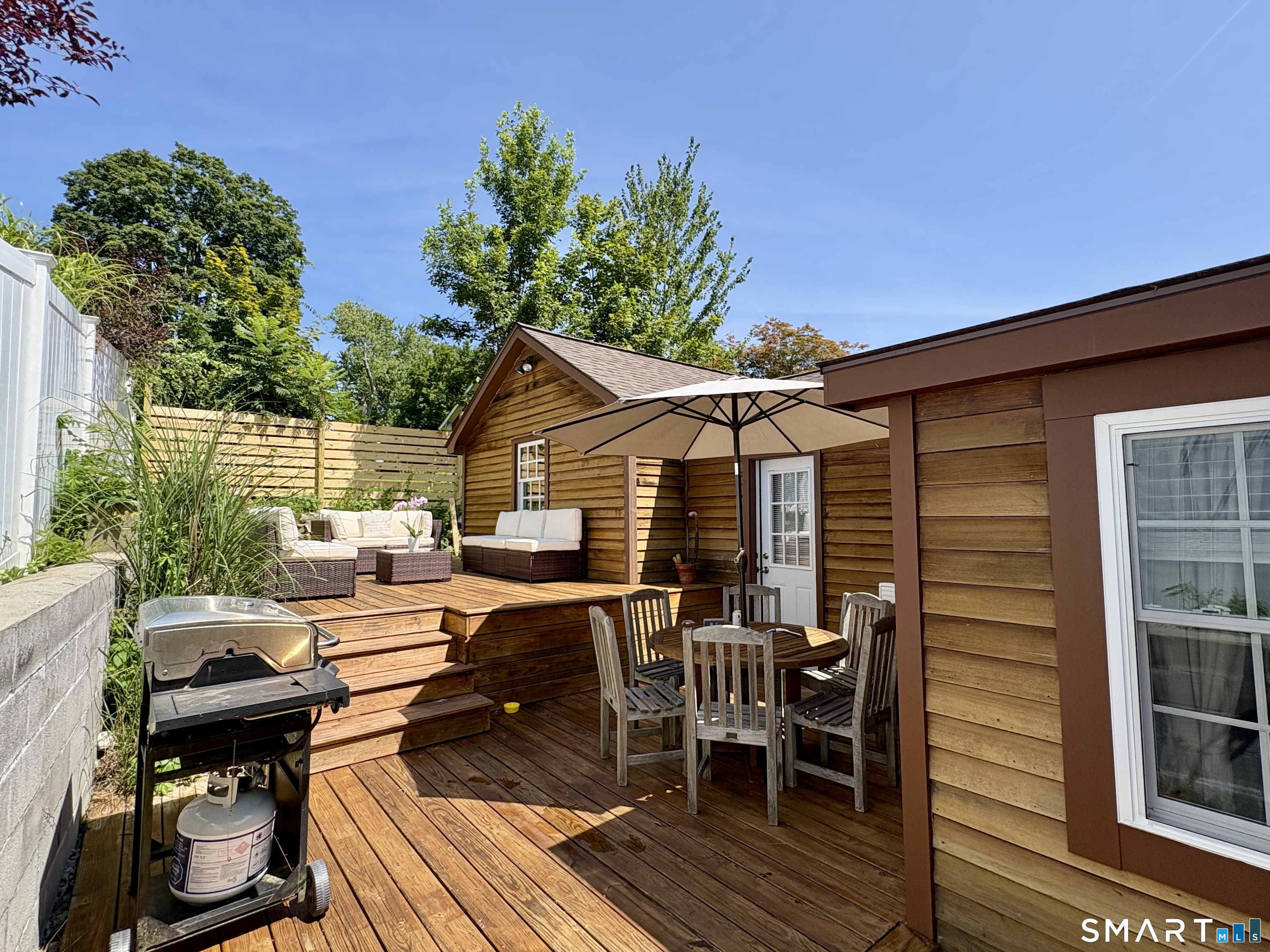 5 Hampton Road New Fairfield, CT 06812 - Photo 27 of 30 a view of a patio with table and chairs and potted plants with wooden floor and fence