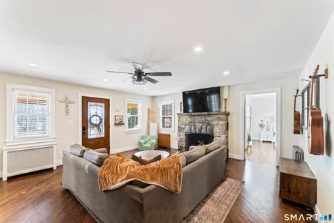 a living room with furniture fireplace and flat screen tv
