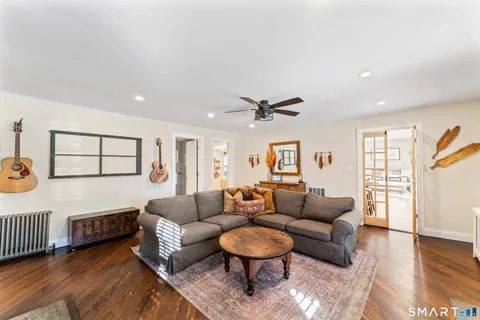 a living room with furniture and a wooden floor