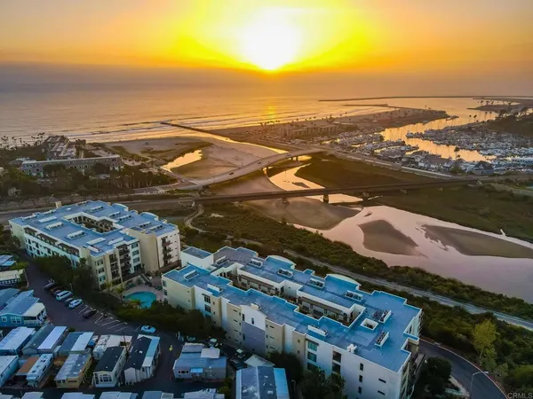 an aerial view of residential building and ocean