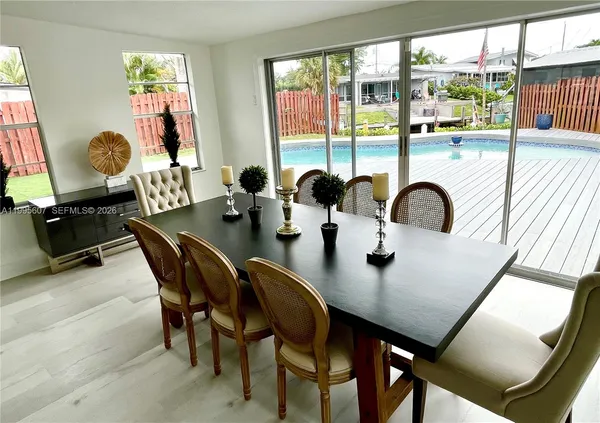 a dining room with furniture and window