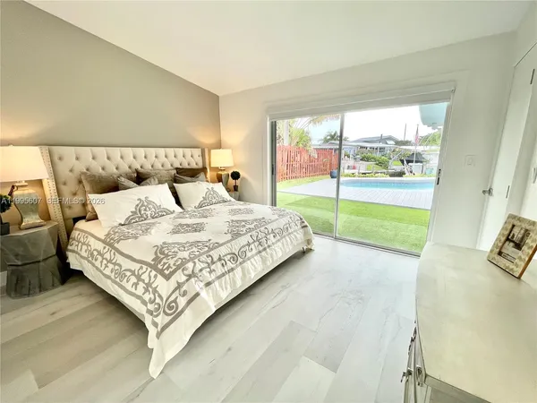 a bedroom with a bed and large window with outer view