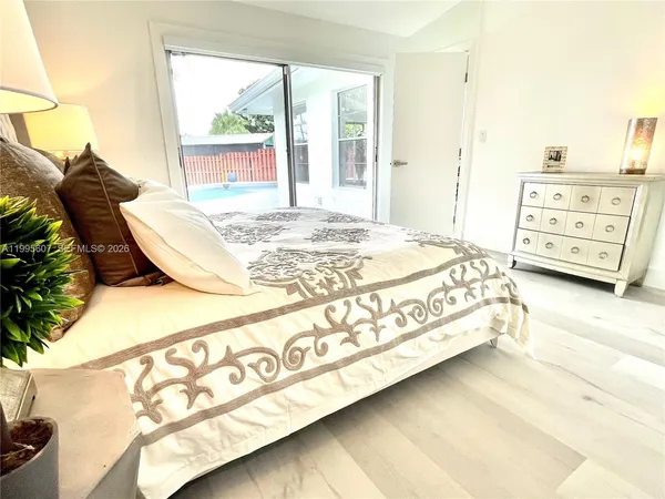 a bed sitting in a bedroom next to a window