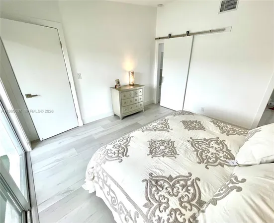 a bedroom with a bed and a mirror