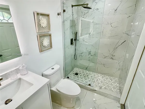 a bathroom with a sink toilet and shower