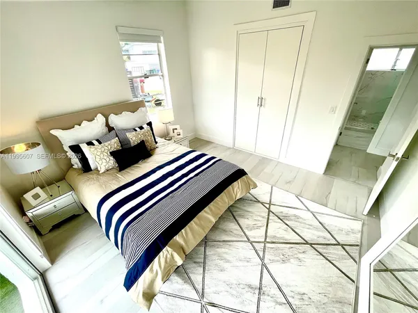 a bedroom with a bed and a mirror
