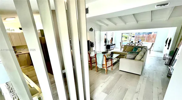 a living room with furniture and a floor to ceiling window