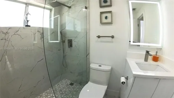 a bathroom with a toilet sink and shower