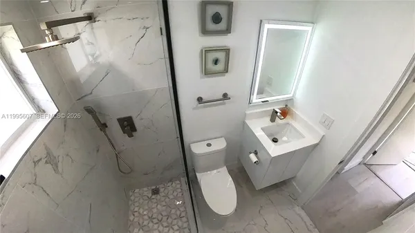 a bathroom with a shower and mirror