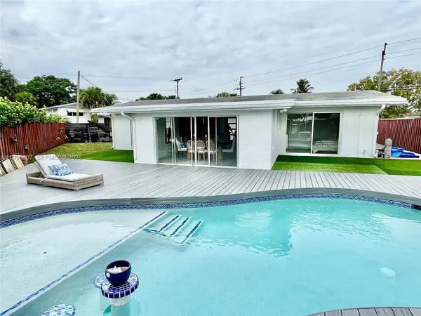 a view of a house with a yard and sitting area