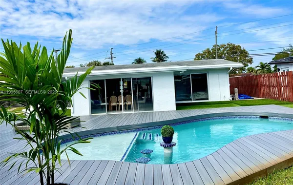 a view of a house with pool and wooden floor
