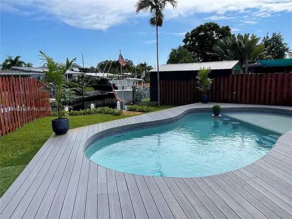 a swimming pool with wooden fence