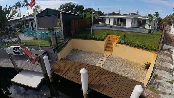 a view of a house with backyard porch and furniture