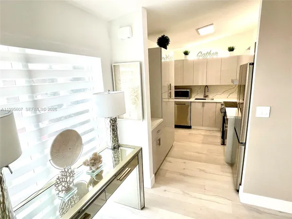 a kitchen with a refrigerator and a stove