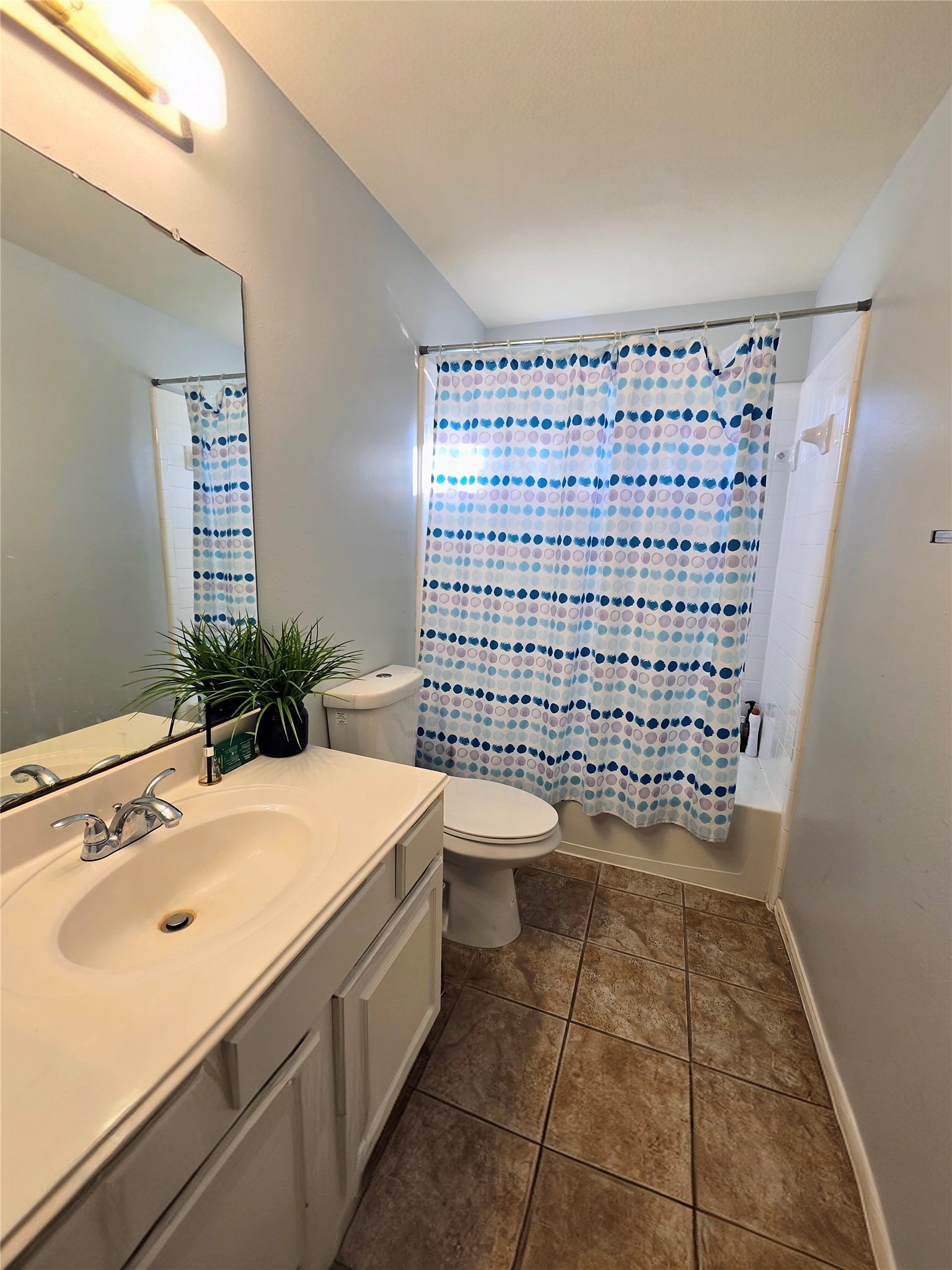 9211 Memorial Grove Drive Spring, TX 77379 - Photo 31 of 38 a bathroom with a sink a toilet and a mirror