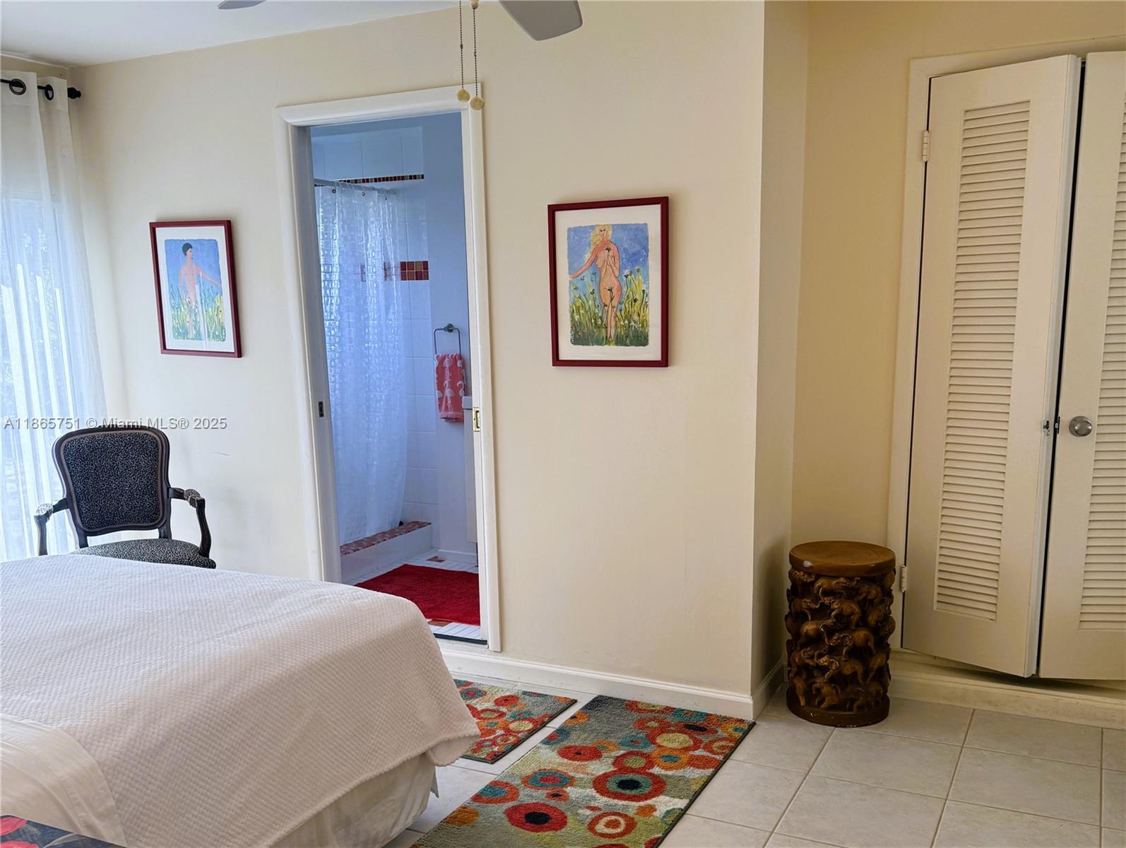 931 Northeast 4th Street, Unit 2 Boca Raton, FL 33432 - Photo 11 of 16 a bedroom with a bed and a window