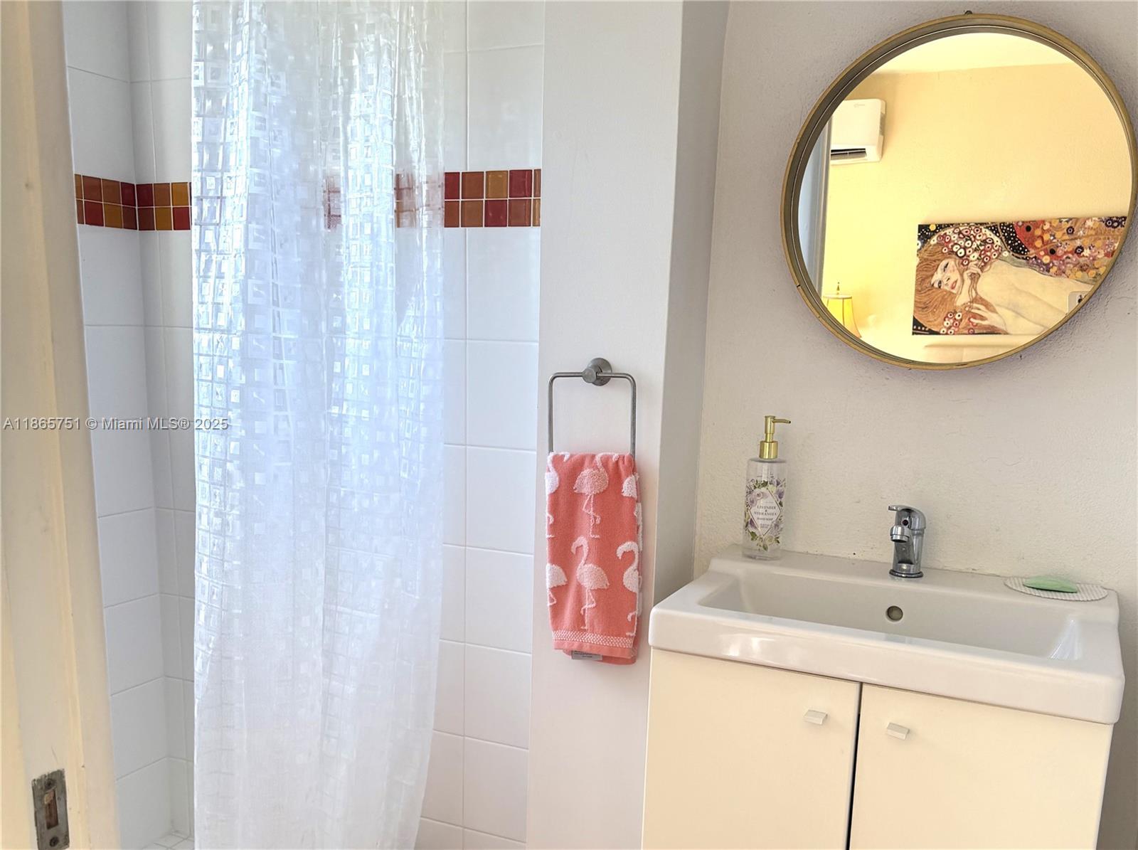 931 Northeast 4th Street, Unit 2 Boca Raton, FL 33432 - Photo 12 of 16 a bathroom with a sink and a mirror