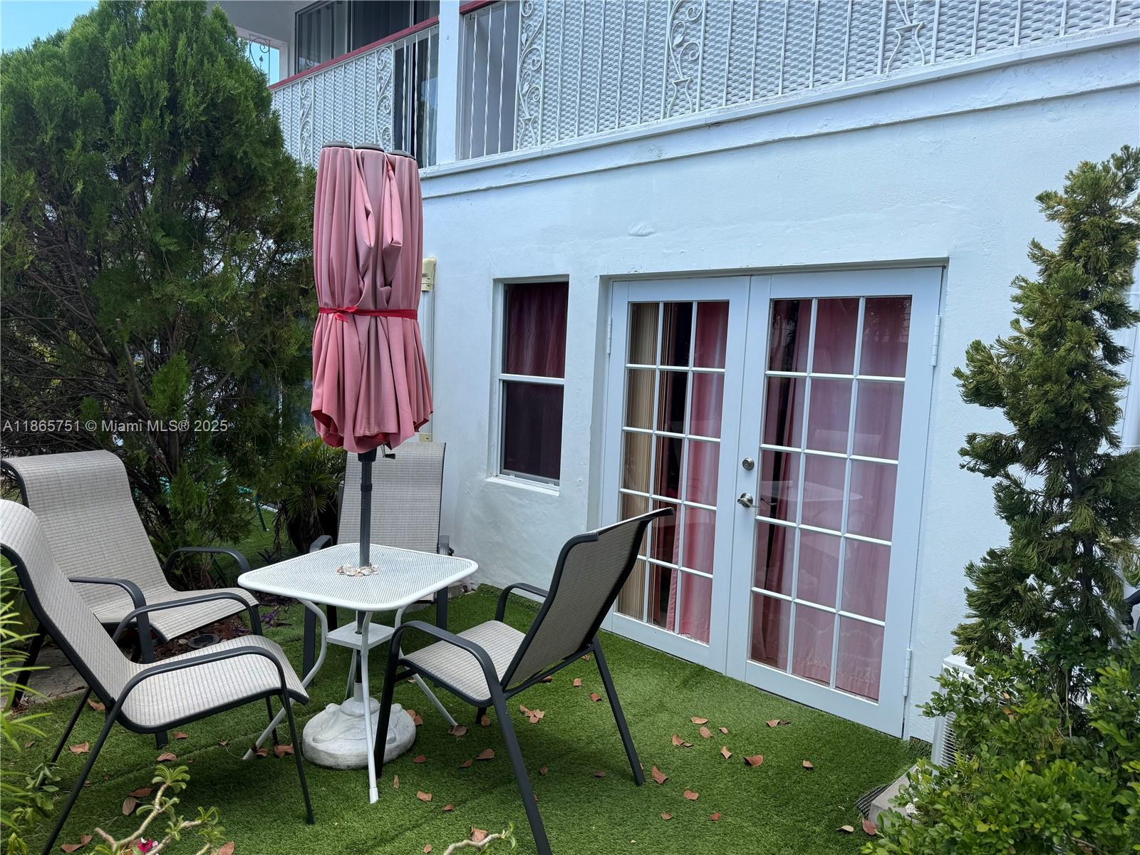 931 Northeast 4th Street, Unit 2 Boca Raton, FL 33432 - Photo 3 of 16 a view of a chairs and table in backyard of the house