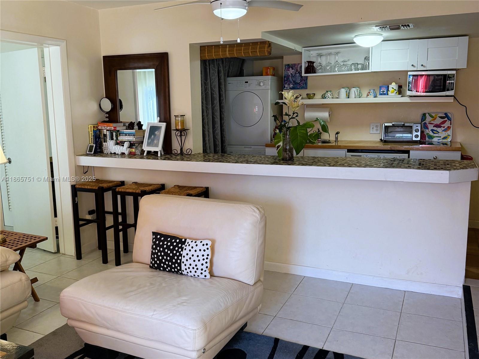 931 Northeast 4th Street, Unit 2 Boca Raton, FL 33432 - Photo 6 of 16 a kitchen with a table and chairs in it