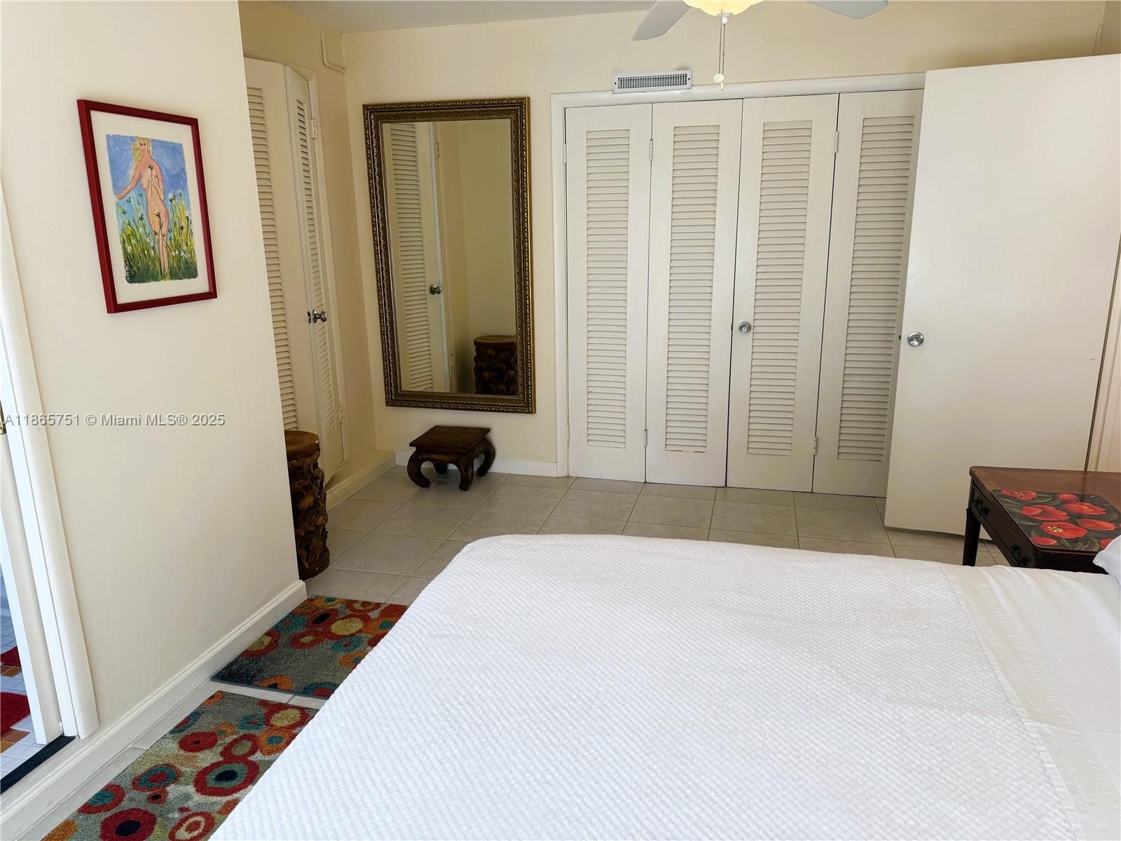 931 Northeast 4th Street, Unit 2 Boca Raton, FL 33432 - Photo 10 of 16 a bedroom with a bed and a walk in closet