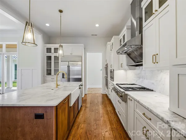 a kitchen with granite countertop a sink stove and cabinets