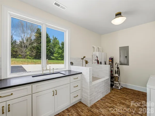 a en suite bathroom with a large window sink and mirror