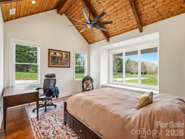 a bed sitting in a bedroom next to a window