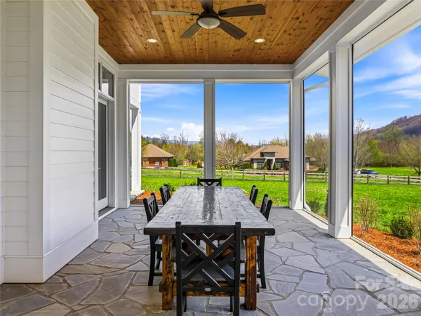 a view of a patio with a table chairs and a backyard