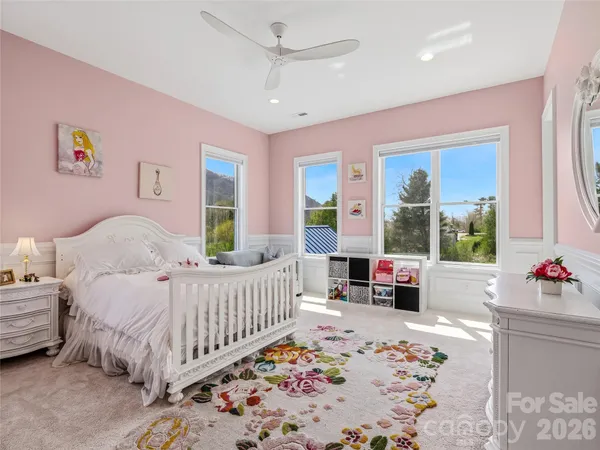 a bedroom with furniture and a large window