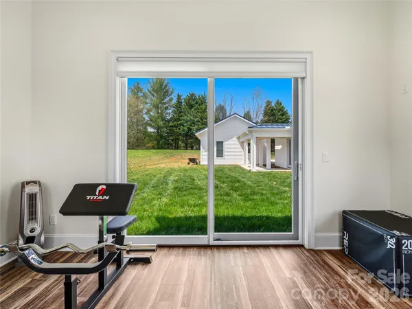 a view of a back yard from a room with furniture water view
