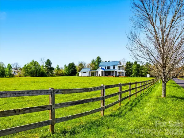 a view of green field with house in the background
