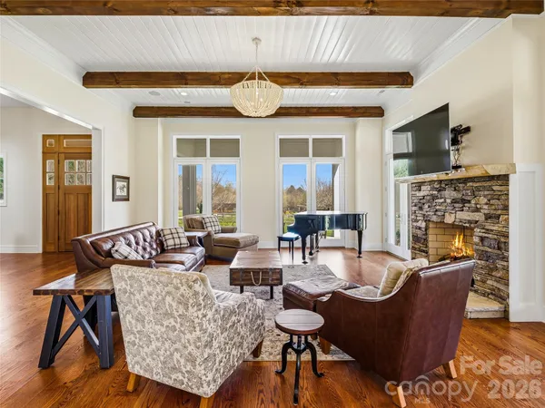 a living room with fireplace furniture and a wooden floor