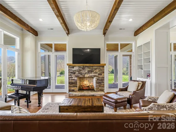 a living room with fireplace furniture and a flat screen tv