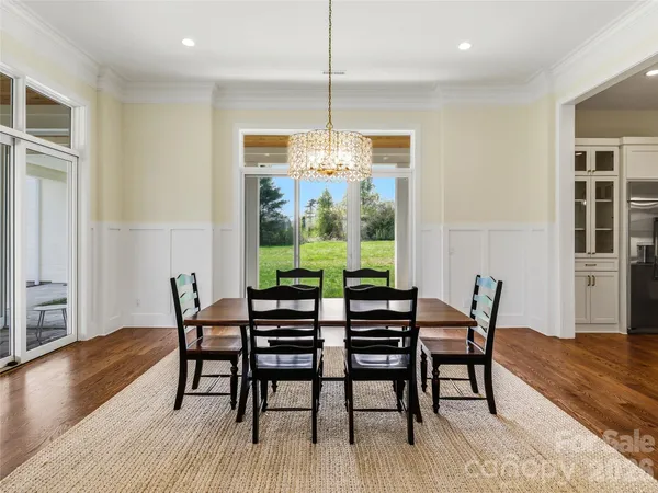 a dining room with furniture window and wooden floor