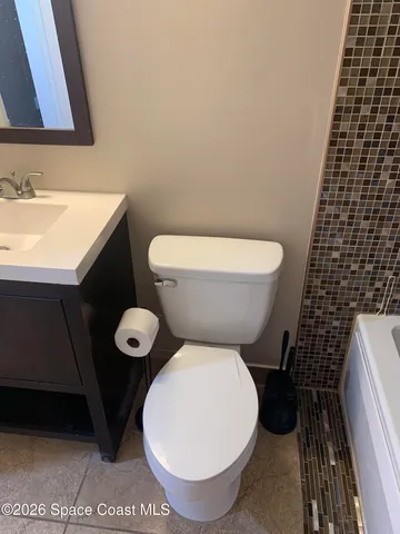 a bathroom with a toilet and a sink