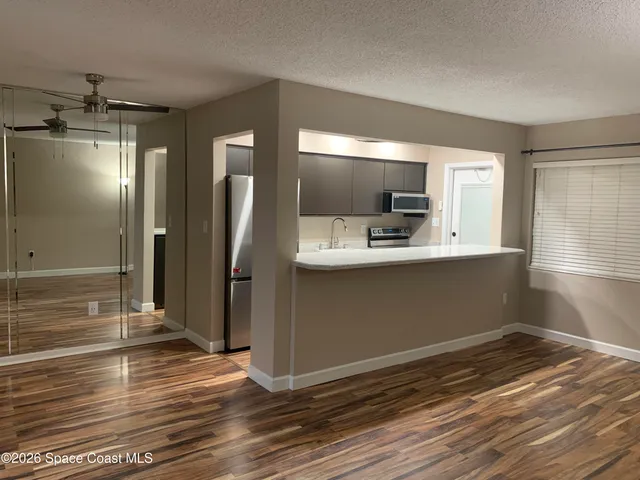 a view of a kitchen from the hallway