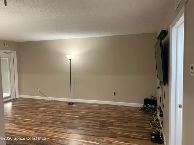a view of a room with wooden floor